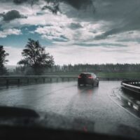 original-bigstock-drive-car-in-rain-on-curve-asp-137504513-500×333